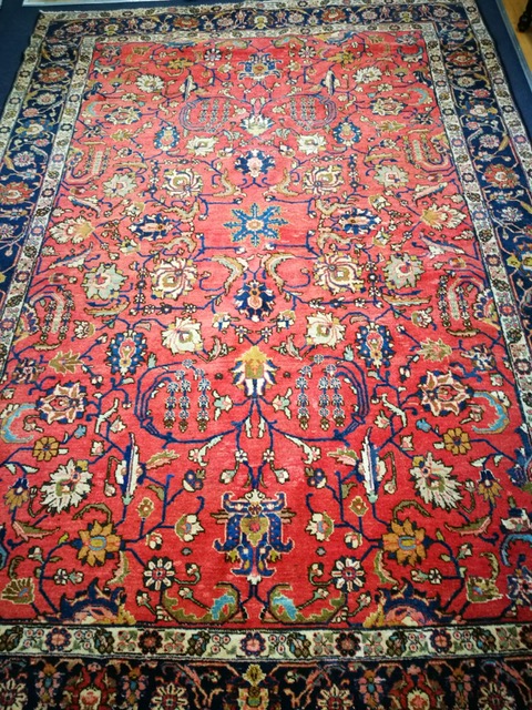 A Persian Heriz red ground rug 310 x 222cm